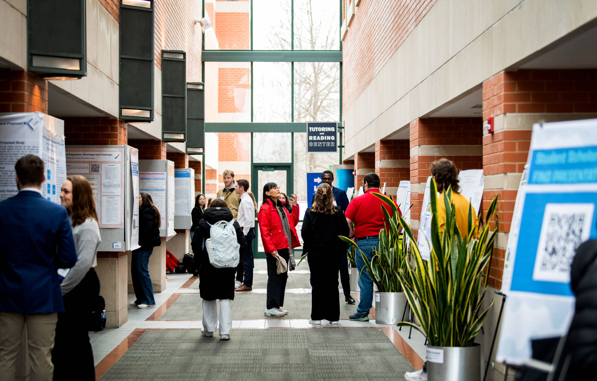 Students and faculty looking at posters at Student Scholars Day.